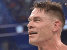 a close up of a man 's face with a w logo on the bottom right