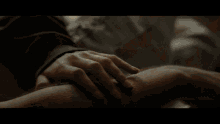 a man and woman laying on a bed with their shirts off