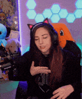 a woman wearing headphones with cat ears and a shirt that says 411