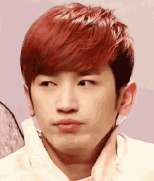 a close up of a young man with red hair making a funny face