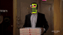 a man in a suit is carrying a box of pizza with a pixelated face on his face