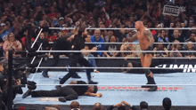 a sign that says legend hangs from a rope in a wrestling ring
