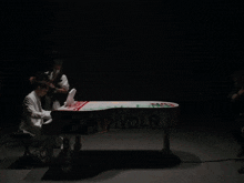 a person is holding a snowboard with graffiti on it that says ' philip ' on it