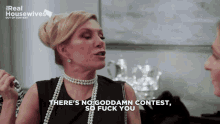 a woman says there 's no goddamn contest so fuck you in front of a real housewives sign