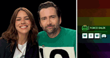 a man and a woman are posing for a picture and the man is wearing a sweater with the number 10 on it