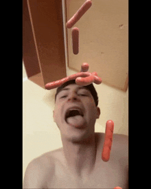 a shirtless man with sausages coming out of his head