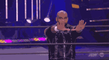 a man in a wrestling ring with aew on the bottom right
