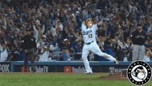 a dodgers baseball player wearing a mascot mask celebrates a home run