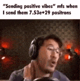 a man wearing headphones is sitting in front of a microphone and says `` sending positive vibes '' .