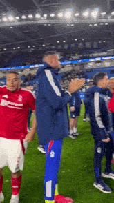 a soccer player wearing a red shirt that says liverpool on it