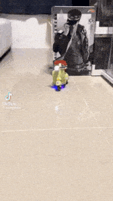 a toy scooter with a person on it is on the floor next to a bed .
