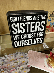 a sign on a table that says girlfriends are the sisters we choose for ourselves