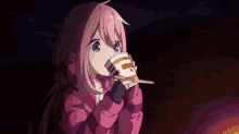 a girl in a pink jacket is eating noodles with chopsticks .