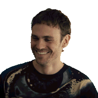 a man with a beard wearing a tie dye shirt smiles for the camera