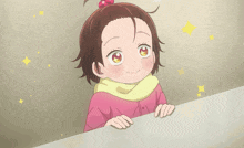 a little girl with a red bow in her hair looks over a wall