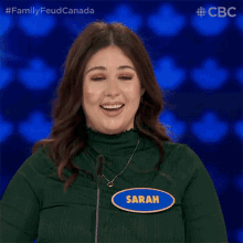 a woman with a name tag that says sarah applauds