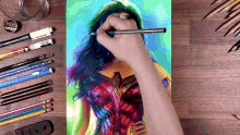 a person is drawing wonder woman with a pencil on a piece of paper