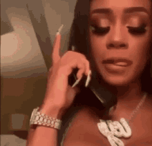 a woman is talking on a cell phone in a hotel room .
