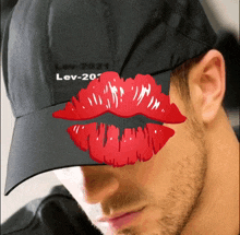 a man wearing a black hat with lev-201 written on it