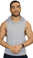 a man with a beard wearing a grey sleeveless hoodie
