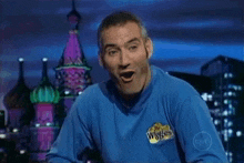 a man in a blue shirt with the word wiggles on it