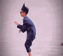 a young boy wearing a hat and sunglasses is standing on one leg