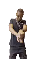 a man wearing a black shirt and black shorts is pointing at something