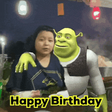 shrek is posing for a picture with a woman with the words happy birthday behind him