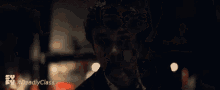 a blurred image of a man with the hashtag #deadlyclass on the bottom