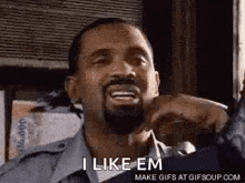 a man with a beard is making a funny face and saying `` i like em `` .
