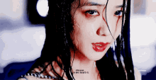a close up of a woman 's face with water drops on it