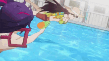 two girls are playing with water guns in a pool