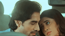 a man and a woman are kissing in the back seat of a car ..
