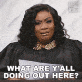 a woman in a judge 's robe is holding a piece of paper and says what are y'all doing out here