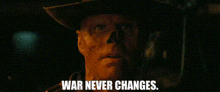 a man in a cowboy hat is holding a gun and says `` war never changes . ''