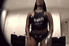 a woman in a black tank top that says bitch
