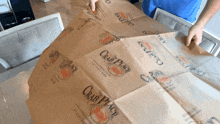 a person is holding a piece of brown paper that says crab place