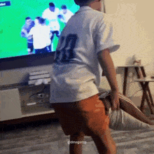 a boy in a white shirt with the number 7 on the back