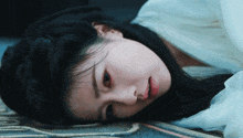 a woman is laying on the floor with blood on her face