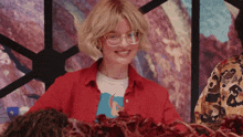 a woman wearing glasses and a red shirt that says ' i love you '