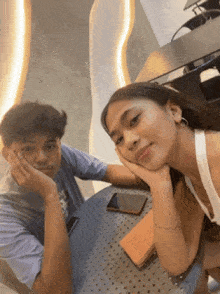 a man and a woman are sitting at a table .