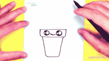 a person is drawing a cartoon character on a piece of paper that says made in animatica