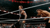 two men in a wrestling ring with a crowd watching and a sign that says ' n live '
