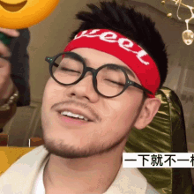 a man wearing glasses and a headband that says weet