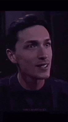 a close up of a man 's face with the word crazy written on it