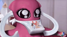 a pink cartoon character is wearing a t-shirt that says ' squid ' on it