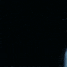 a woman with long black hair is wearing a white jacket with a star on it