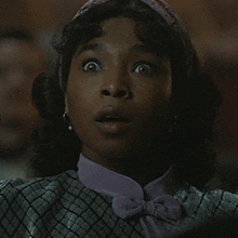 a close up of a woman 's face with a surprised expression
