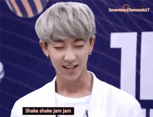 a young man with gray hair is smiling and talking about shake shake jam jam .