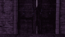 a man is standing in a doorway with his arms outstretched in a dark room .